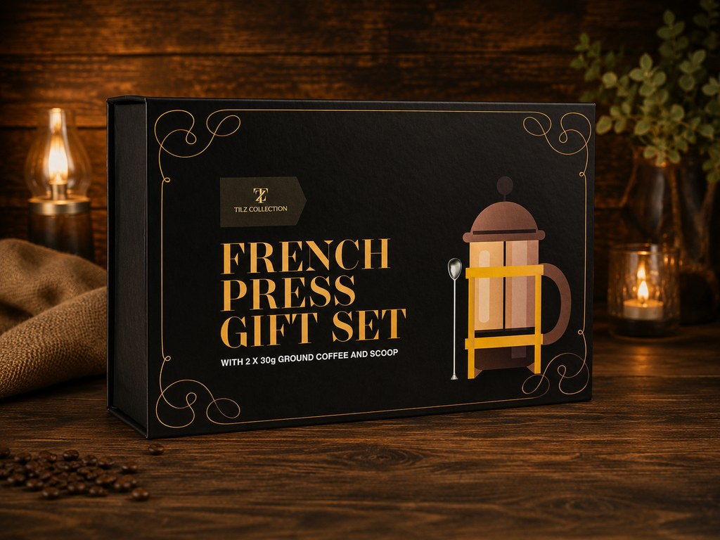 Tilz Collection French Press Coffee Gift Set premium black and gold box front view on rustic wooden surface with candles and coffee beans