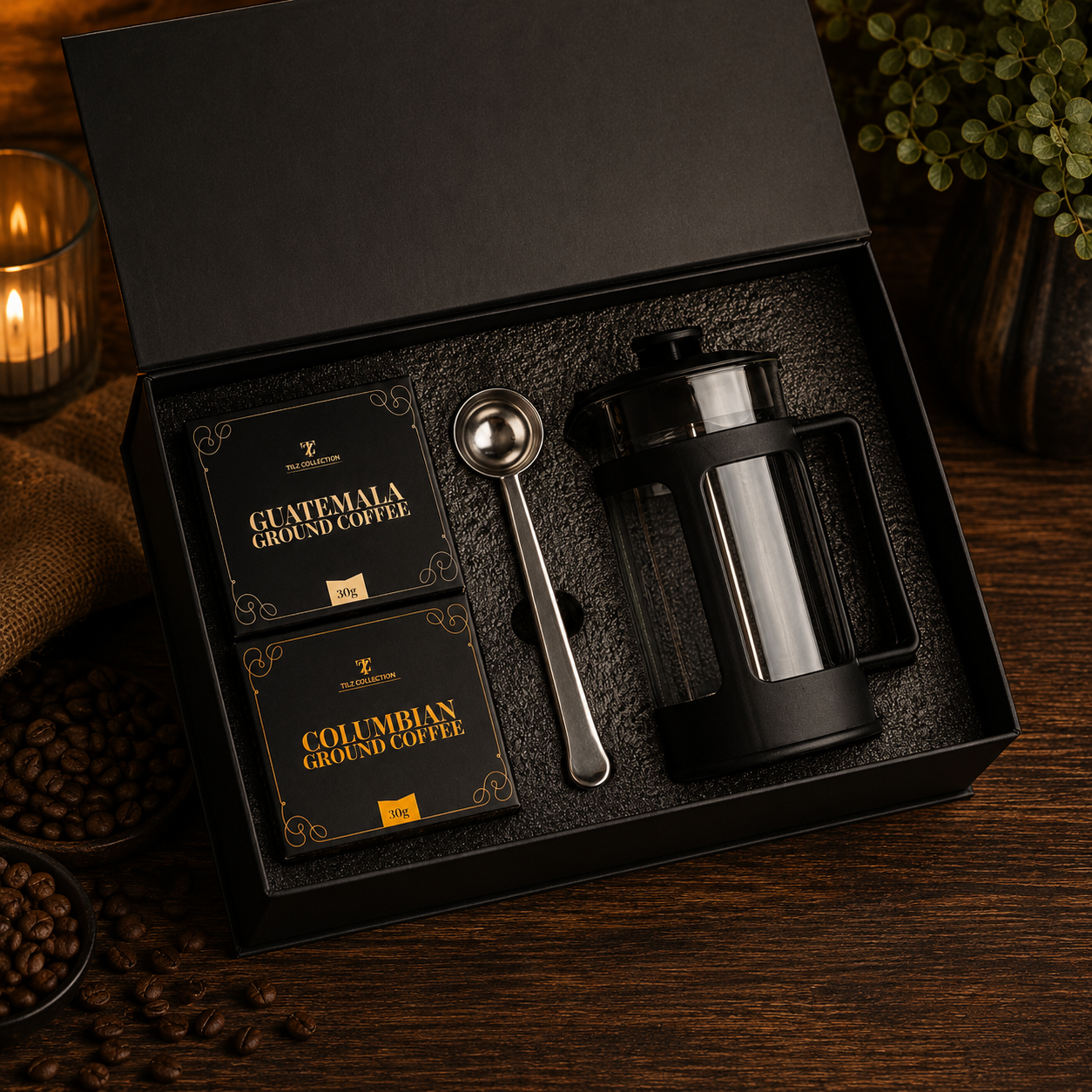 Tilz Collection French Press Coffee Gift Set open box showing cafetiere ground coffee packs and measuring scoop in premium black gift packaging on wooden surface with coffee beans