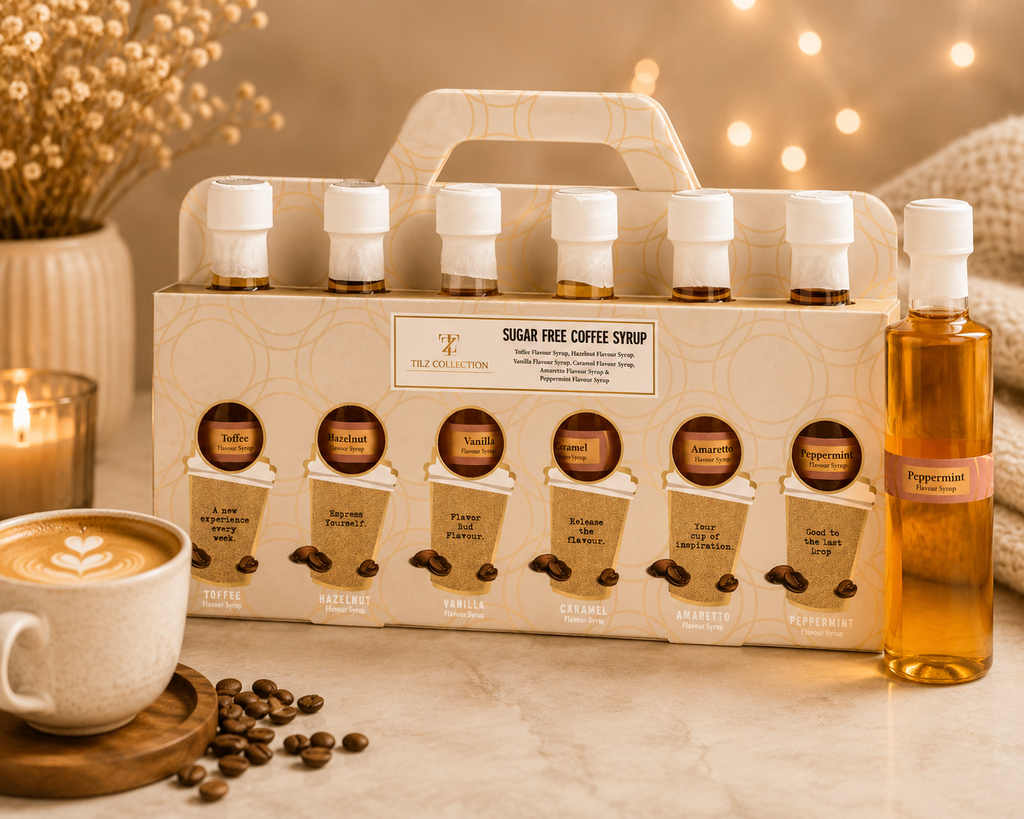 Tilz Collection Sugar Free Coffee Syrup Gift Set front view showing 6 bottles in premium carrier box with peppermint syrup bottle displayed alongside latte art coffee cup and roasted coffee beans